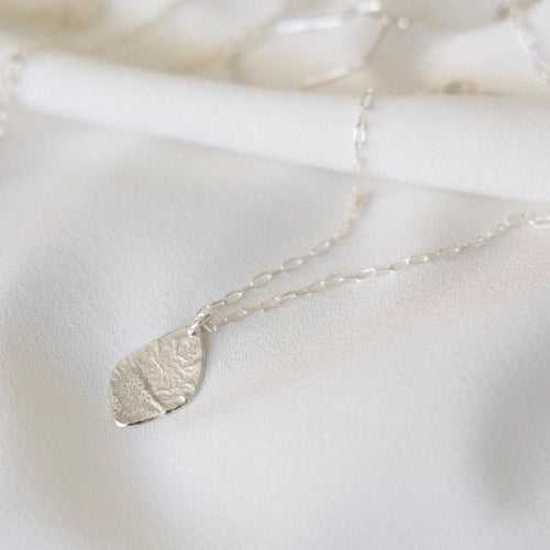 תליון כסף סטרלינג מדגם אש המציג מרקם גולמי ודינמי הנוצר בתהליך חימום מתקדם, תכשיט אמירה מלא עוצמה ותנועה.