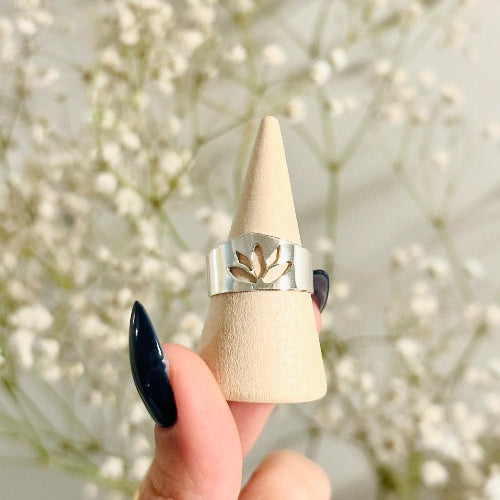 טבעת לוטוס מכסף סטרלינג במבט מקרוב, המציגה את הדיוק בחיתוך האומנותי של הפרח על גבי טבעת רחבה ומרשימה.